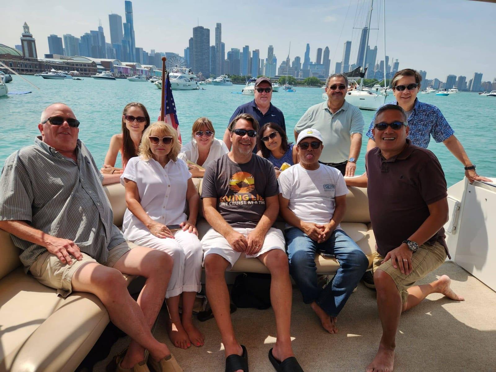 ISG teammates on a boat with the Chicago skyline behind them
