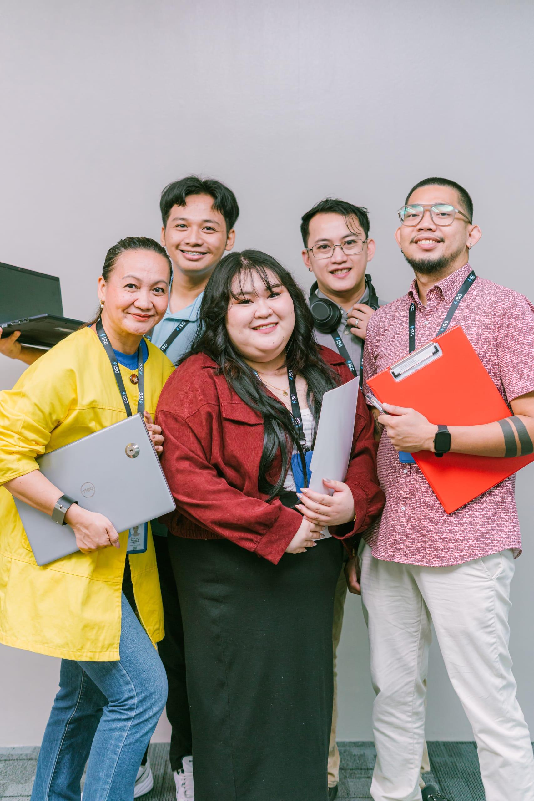 ISG teammates with laptops and clipboards